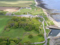 The boundary wall marks the grounds that used to surround Castlehill House, some remains of which can be seen on the right hand side. The original dri