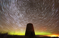 Star trails and aurora over the Castlehill wind pump tower
