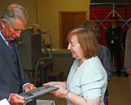 Liz Geddes, Vice Chairman of CHS presents HRH with a Caithness Flagstone plaque laser etched with an image of the Castlehill Windpump Tower and the Pi