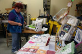 Carmel demonstrating speciality embroidery using a computer controlled sewing machine - items were available to order on the day