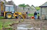 Pause for thought. Gordon inspects progress by John in clearing debris from a collapsed section of water channel.