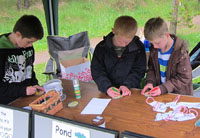 Olympians hard at work decorating their 'ring' trophy