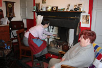 Enjoying the fruits of their labours...Carmel awaits a freshly made bannock