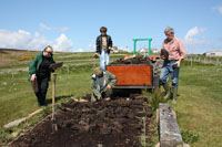 Making a start at the peat stack at Mary Ann's Cottage
