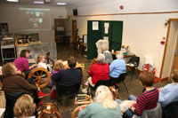 The spinners listen as each on-line group explains in turn about their activities and participation in the event.