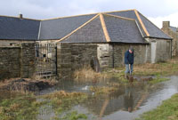 Keith on flood mitigation duties. The water can be seen bubbling up out of the ground in the mid foreground