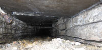 A visual check further down the channel confirms all is clear. The detail of the original wall construction is clearly visible