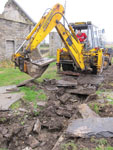Carefully does it. Much easier than lifting by hand!! The debris in the channel is visible in the foreground