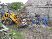 Hugh, John and Gordon make light work of dismantling one of the redundant sections of wall at the south end of the Heritage Garden.